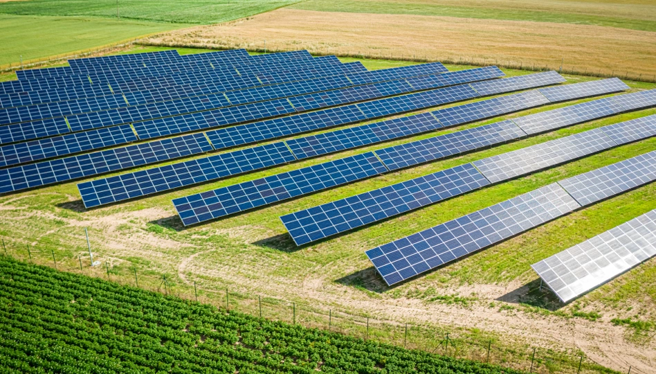 Scrap metal crane loading material near wind turbines